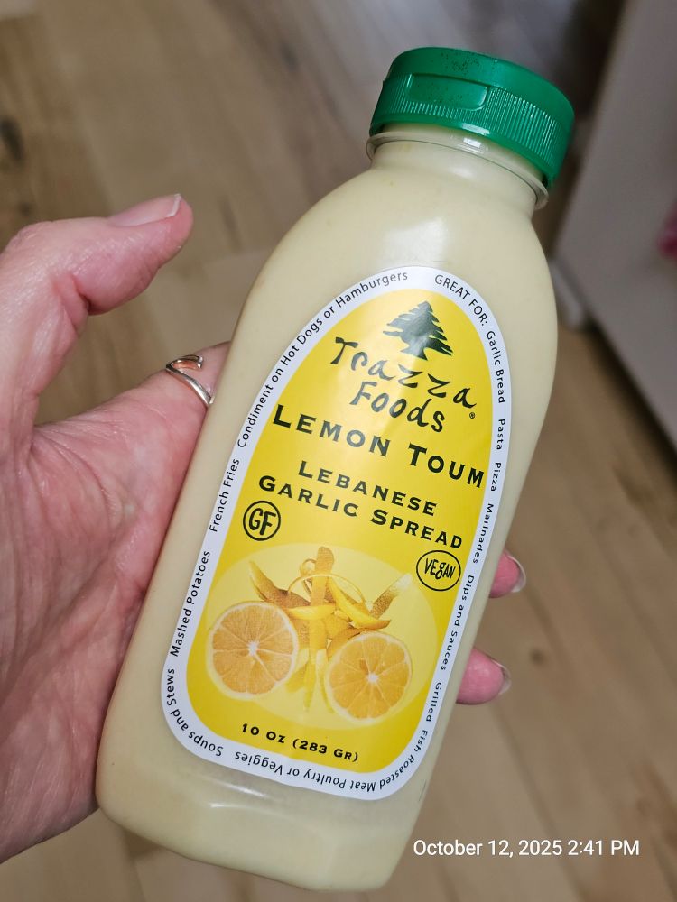 A squeeze bottle labeled "Trazza Foods – Lemon Toum – Lebanese Garlic Spread"