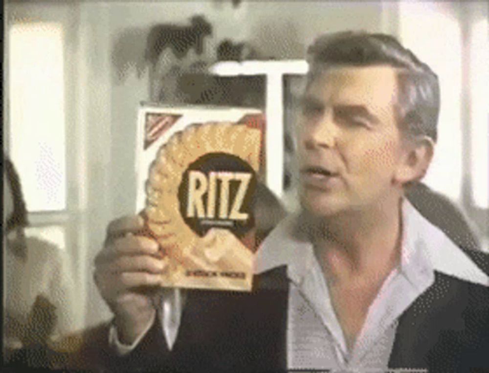 a man is holding a box of ritz chips in front of his face