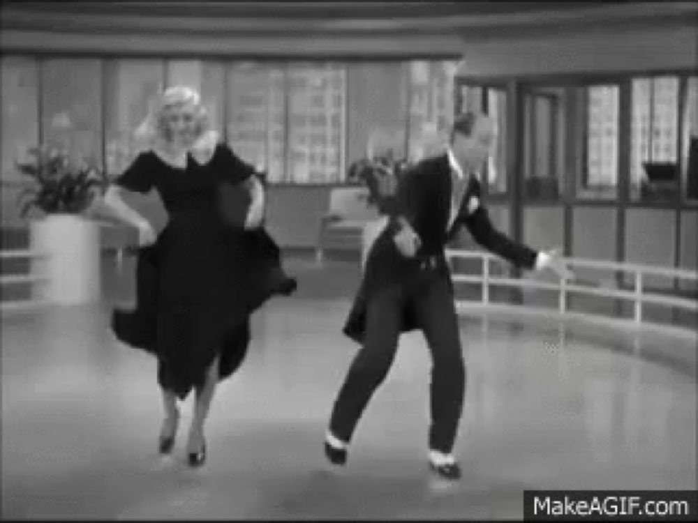 a black and white photo of a man and a woman dancing on a ice rink .