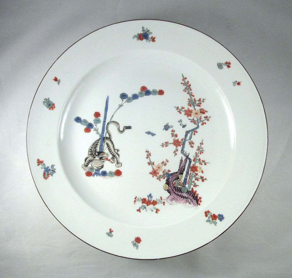 A circa 1745 Meissen porcelain charger painted with Kakiemon-style decoration in the Gelber Löwe pattern, picturing a tiger snaking around a bamboo tree on the left and a flowering prunus tree on the right, and with a brown line along the rim.

PROVENANCE
Collection of Augustus III (1696-1763) Elector of Saxony and King of Poland.
Christie’s, London, 1 March 1993, lot 189.
Christie’s, London, Sale 17346, Visions of Collecting: Royal and Aristocratic, An Important Private Collection, 19 September 2019, lot 90.
