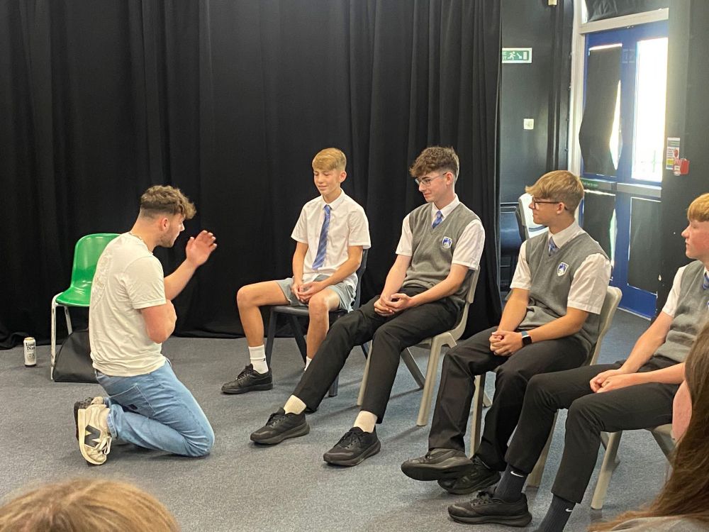 The actor interacts with the audience of students