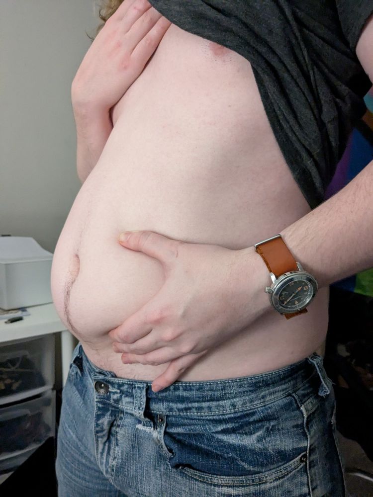 Doll squeezes his soft full belly. His jeans are very tight around his hips