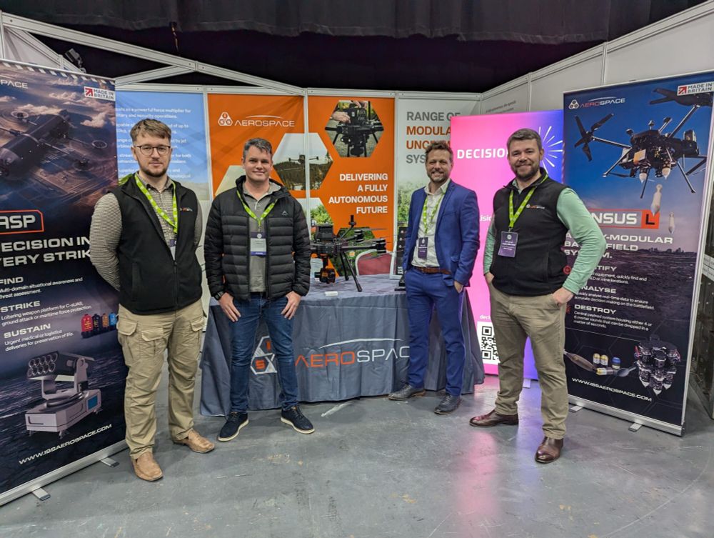 Decision Lab CEO, David Buxton, and Head of Tech and Innovation, Damien Lopez, at the shared ISS Aerospace stand at the NDA Supply Chain event showcasing autonomous drone tech for site security.