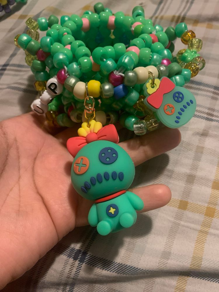 Green kandi bracelet with scrump charms from lilo and stitch.