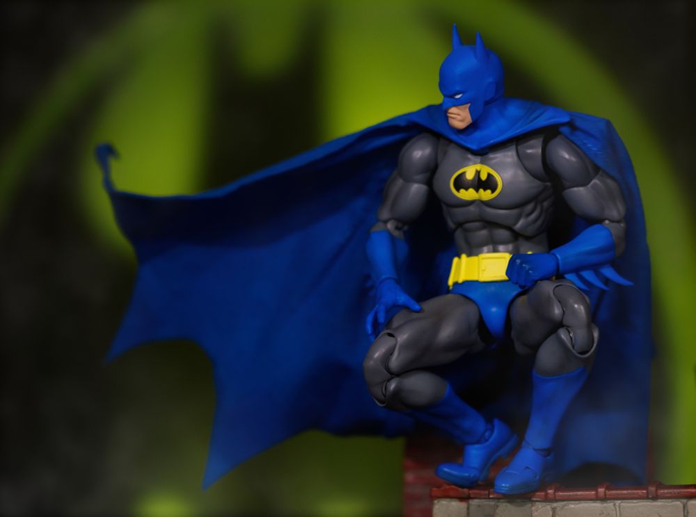 Mafex Batman on a rooftop with the bat signal behind him 