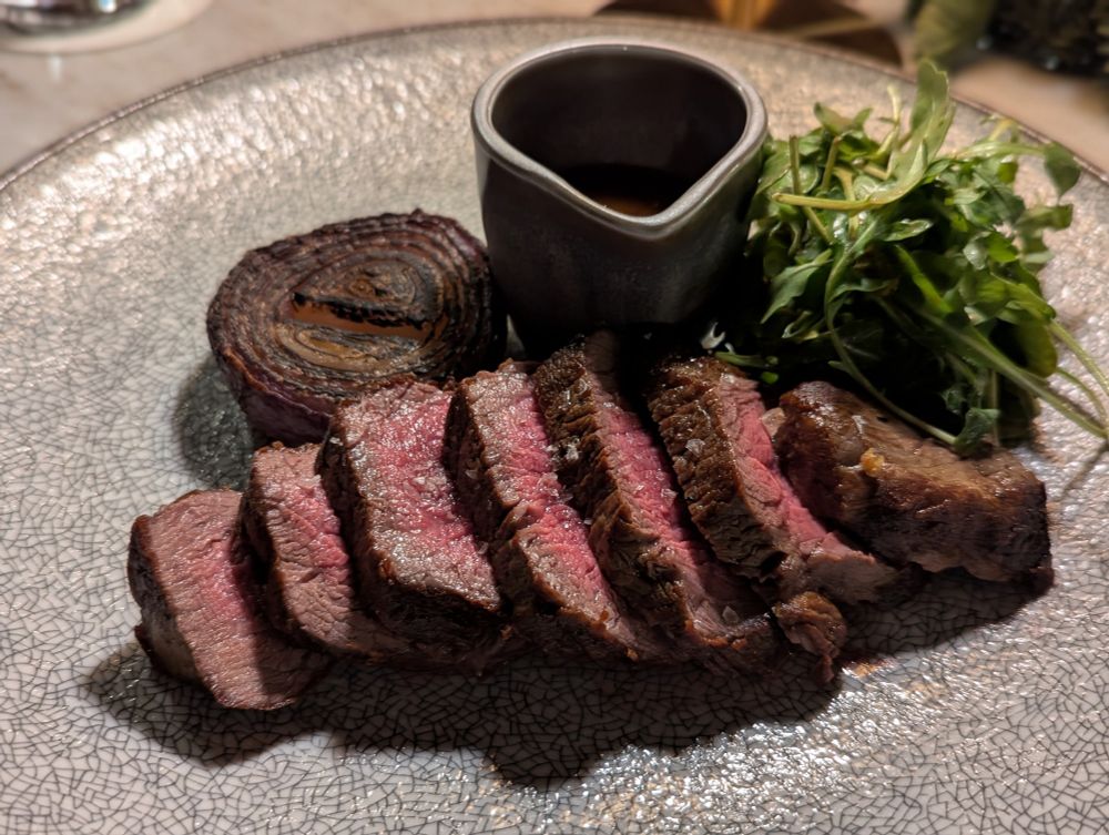 Med rare cooked steak with roasted onion 