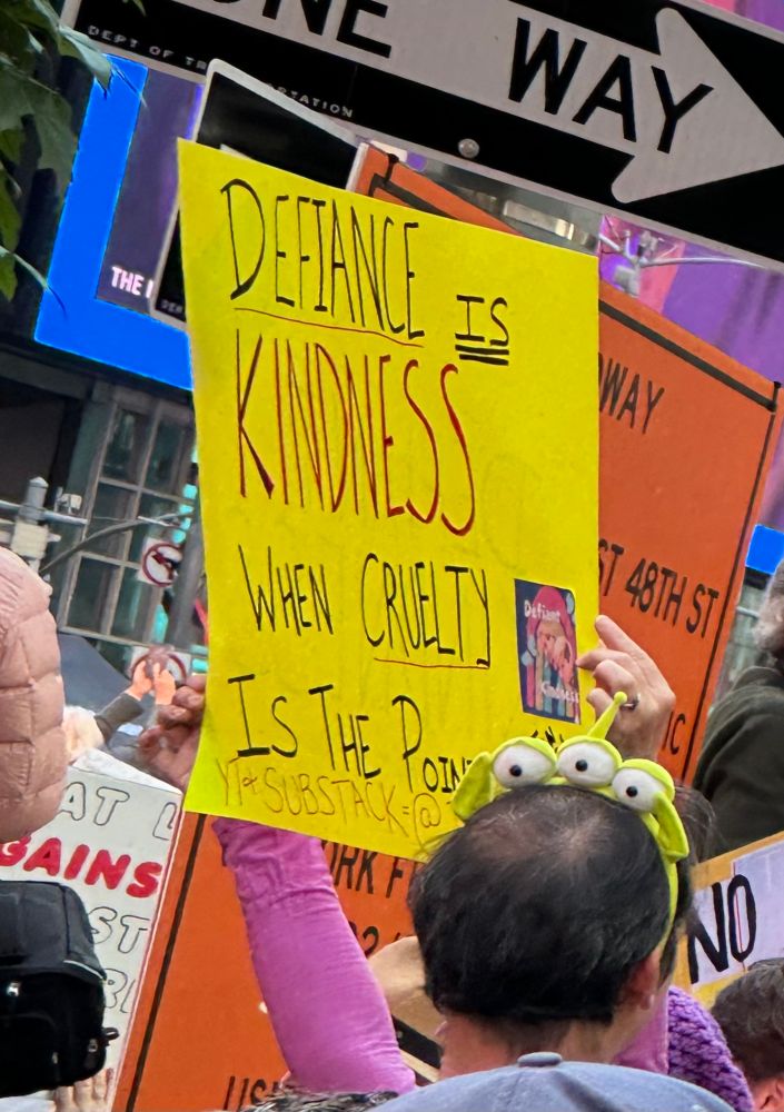 Protest sign that says, “defiance is kindness when cruelty is the point”