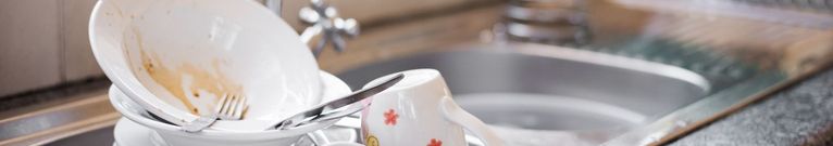 unwashed dishes photo, stacked at a modern sink