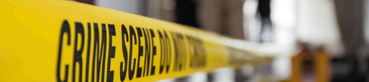 photo crop banner, crime scene do not cross yellow tape hanging in a modern world setting.