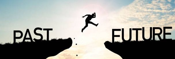 Photo manuplation of a man leaping from one cliff called Past through a gap towards another cliff called Future.