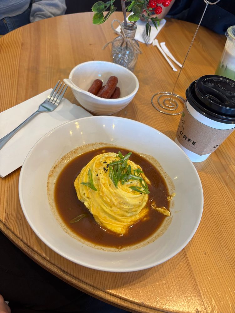 A plate of omurice and coffee.