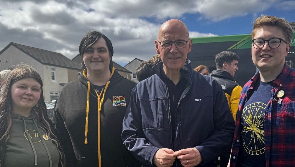 Four individuals in a photo. From left to right:

National Equalities Convener for the Scottish National Party

Out For Independence’s Non-Portfolio Officer

John Swinney MSP, Leader of the Scottish National Party

Out For Independence’s Co-Convener