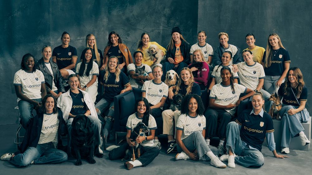The Reign FC roster poses with their pets in the new kits featuring Trupanion as the front-of-kit sponsor. 