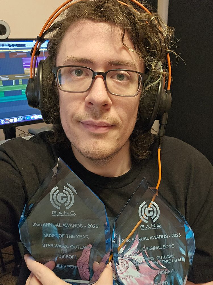 Me with two game audio network guild trophies from 2025