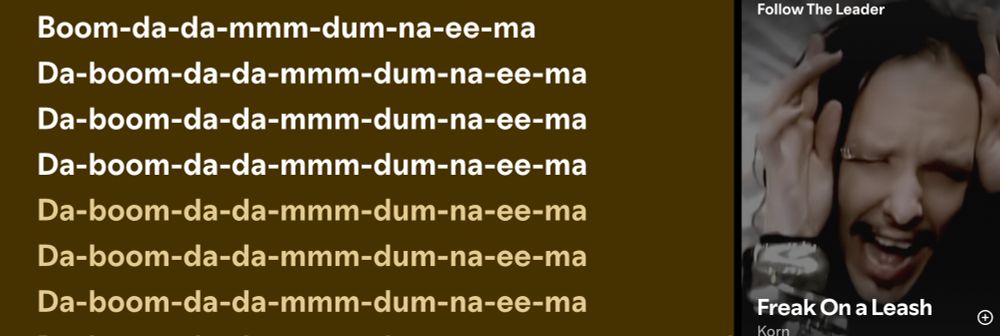 Screenshot of Spotify showing some of the lyrics ("Da-boom-da-da-mmm-dum-na-ee-ma") from Freak on a Leash, by Korn