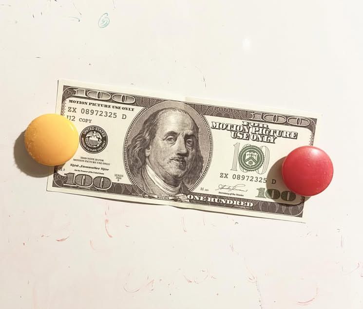 On the magnetic whiteboard in my kitchen, held in place by two round magnets (one yellow, one red), a fake US$100 bill marked 'FOR MOTION PICTURE USE ONLY'.

(We'll gloss over the fact that it was used in a stage production rather than a film.)
