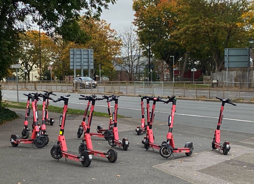 On Wellington Street in Slough, a mass of rentable e-scooters - about 15 of them - blocking the pavement.