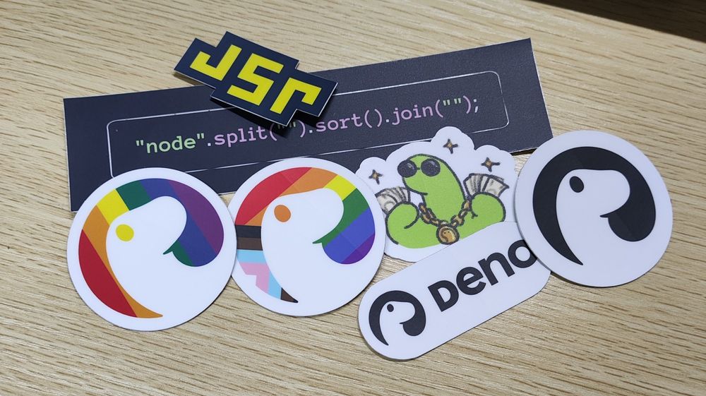 Some Deno stickers on the table:

Deno logo with progress flag
Deno logo with rainbow flag
Deno logo with text
Rich Deno
JSR
Pure Deno brand logo
Sticker with code: "node".split().sort().join("");