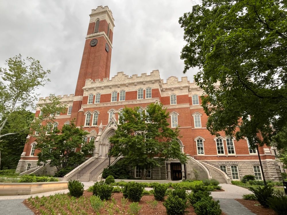 Vanderbilt University’s Kirkland Hall with darkened clouds above and greenery in front