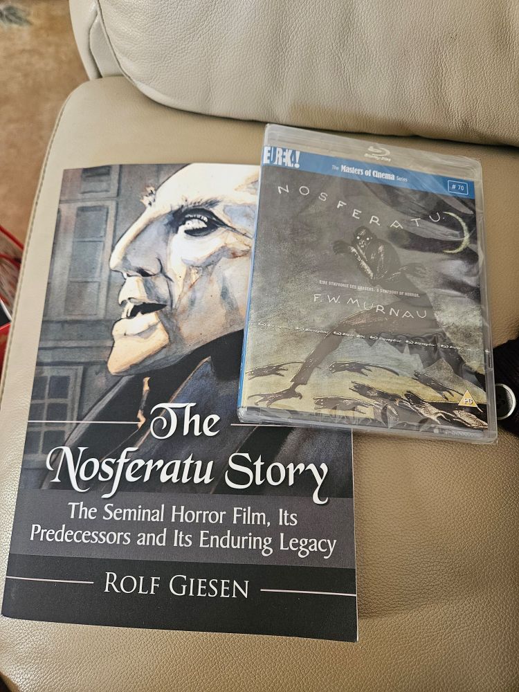 A copy of The Nosferatu Story: The Seminal Horror Film, Its Predecessors and It's Enduring Legacy and the bluray of Murnau's Nosferatu. 