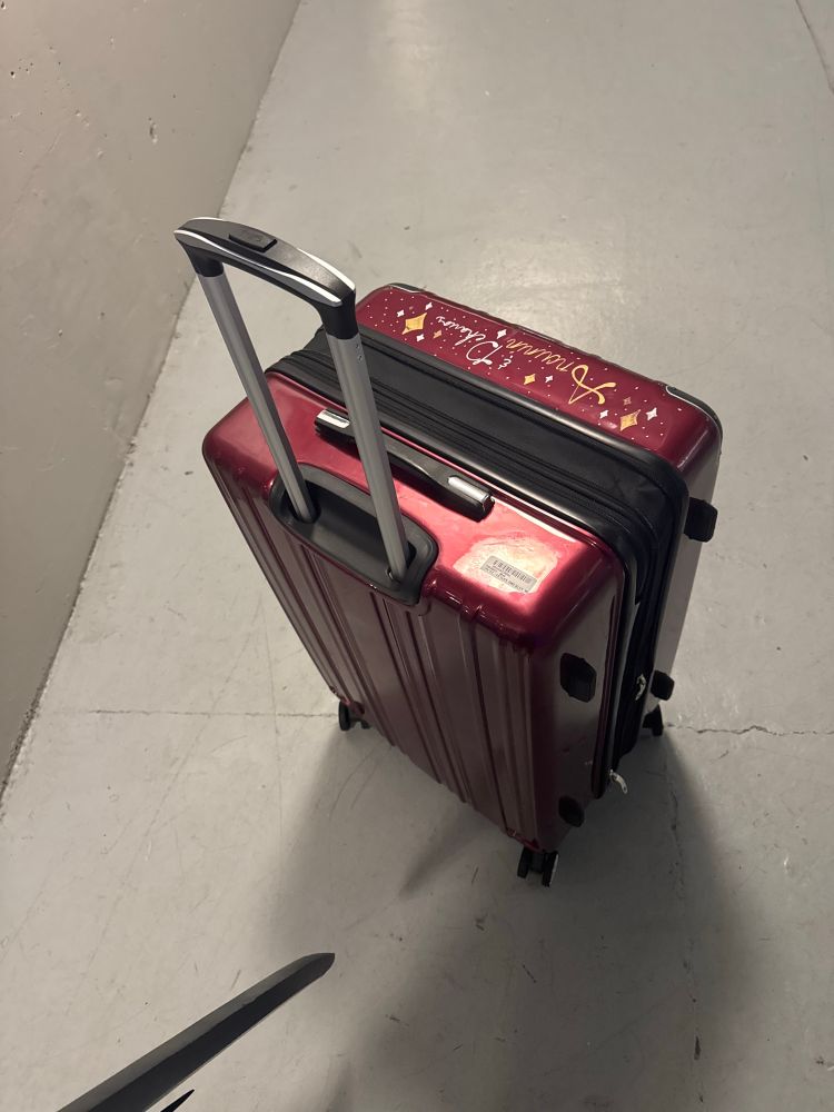 A red hard body suitcase, all the way expanded