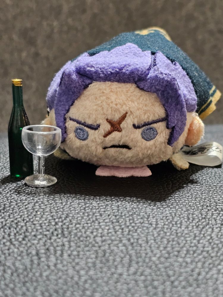 a barok van zieks tsum tsum sitting next to a tiny chalice and bottle of wine