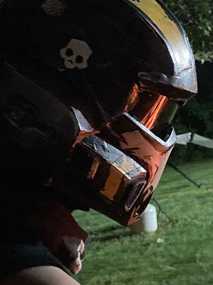 A diver staring into a fire that’s reflected in their visor 