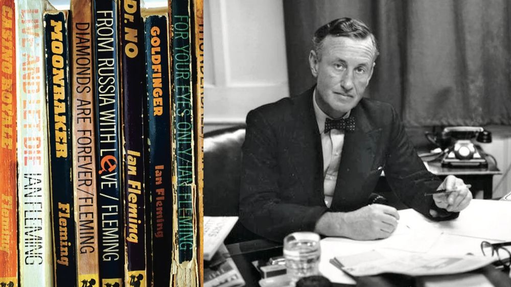 British author Ian Fleming at his desk, wearing a bow tie and holding a pen in his left hand; a pile of papers, possibly drafts of a story or novel, is on the desk before him. To his left are pictured hardback and paperback book covers and spines with the titles of many of Fleming's James Bond novels.