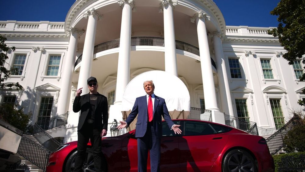 Trump and Musk in front of a Tesla at the White House