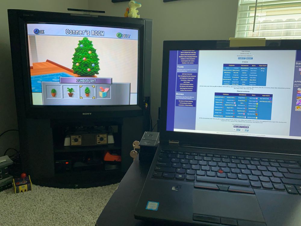 A TV showing the JumboPlant in Pokemon Stadium 2, and a Laptop showing Blue Moon Fall’s decoration tracking tool.