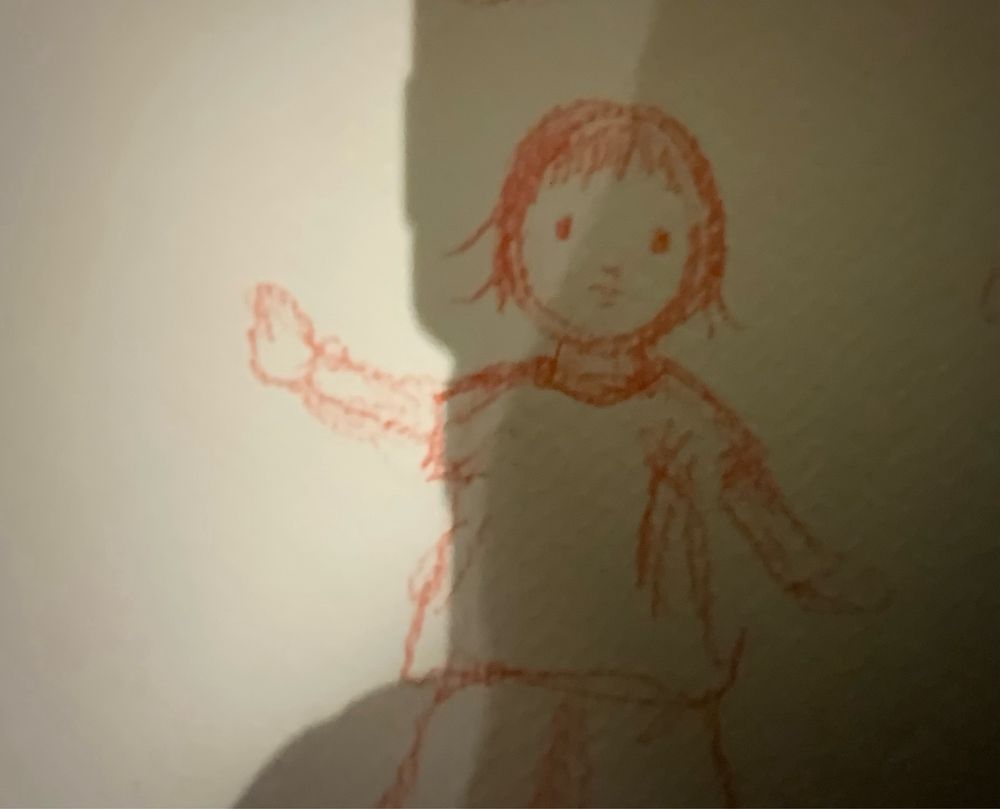 A sketch of a child inred pencil pointing 