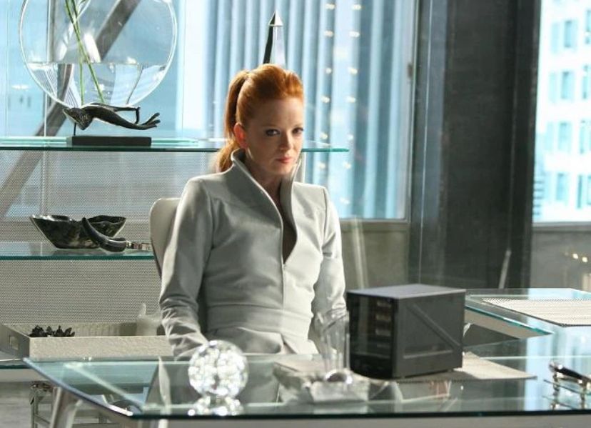 Shirley Manson in her role on the TV series Terminator: The Sarah Connor Chronicles. She sits behind a glass desk, surrounded by glass, chrome and brushed steel, wearing a steel grey suit. She is definitely not a Terminator. Nope. Impossible...WHAAAAAAAAAA!?! 