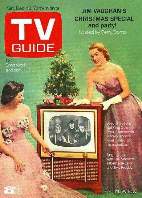  1950s TV Guide cover: Two women in pink purplish dresses looking at a tv with a Christmas tree on the top of it.