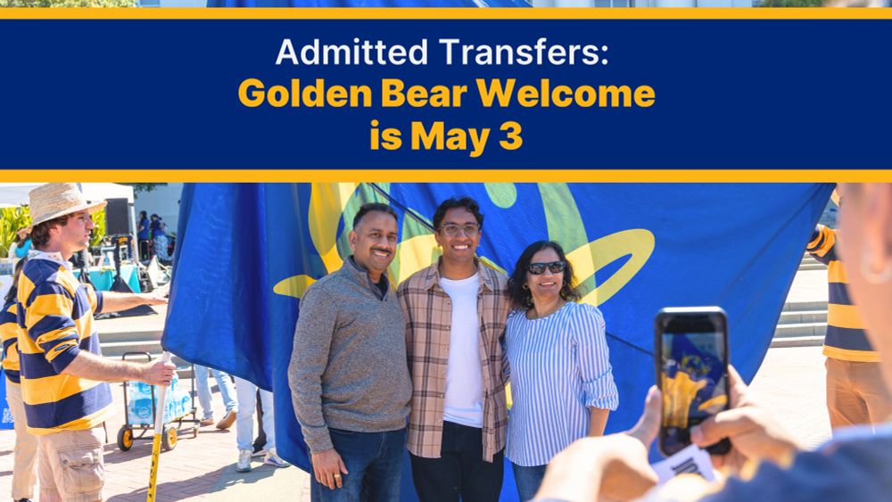 A family takes a photo at an on-campus event in front of a Cal flag.