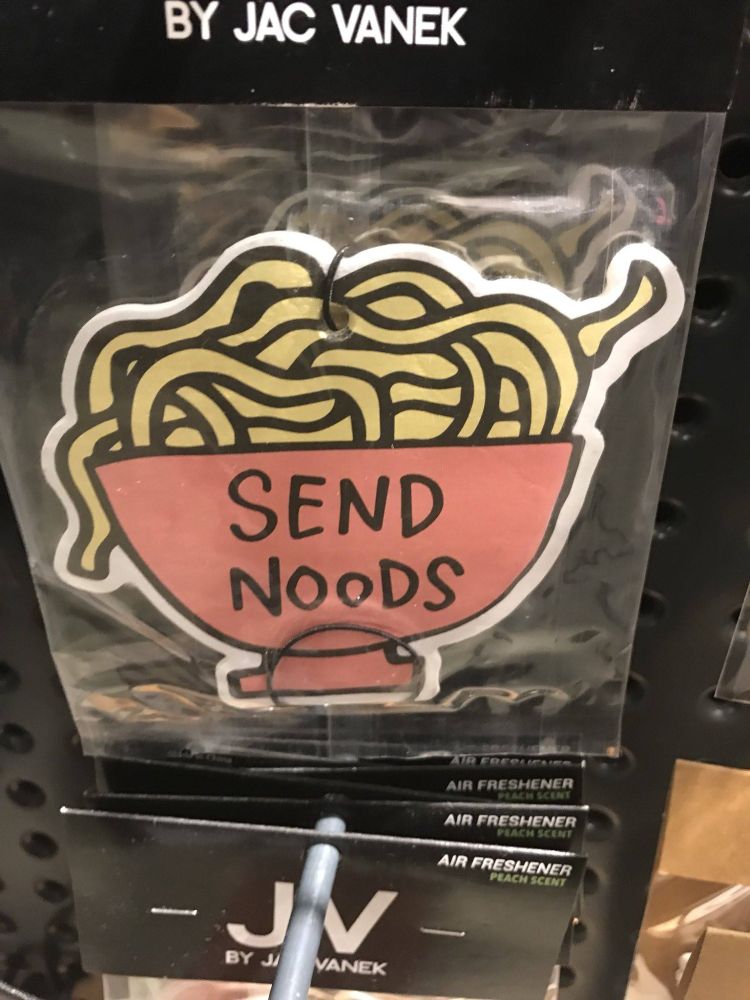 A car air freshener. It is shaped like a bowl of pasta, and it has "Send Noods" on the side