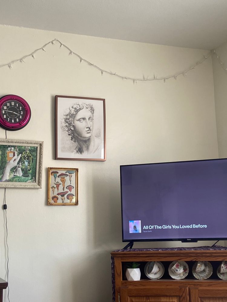 corner of my living room with all of the girls you loved before by taylor swift playing on the tv