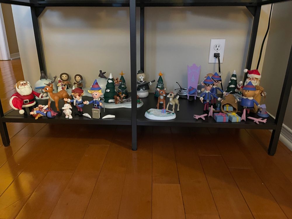 Action figures from the 1960s claymation Rudolph the Red Nosed Reindeer film set up on a shelf.