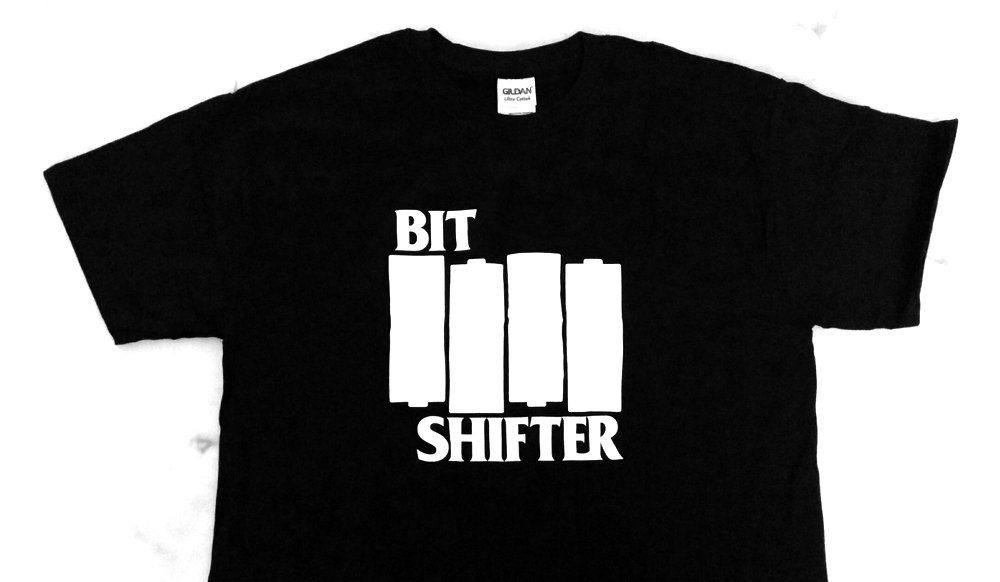 Photo of a Bit Shifter t-shirt that spoofs the iconic Black Flag logo by turning their flag emblem into the 4×AA batteries, in alternating orientation, familiar to anyone who's put batteries into a DMG Game Boy