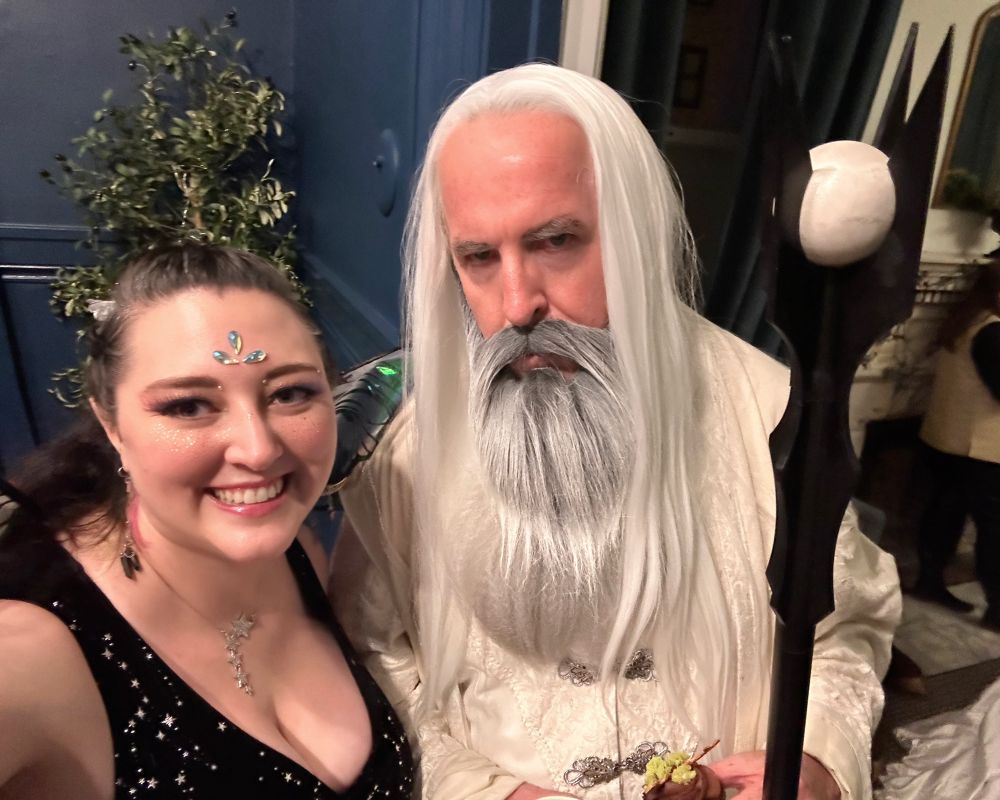 Amy with a gentlemen dressed as Saruman (including wizard's staff)