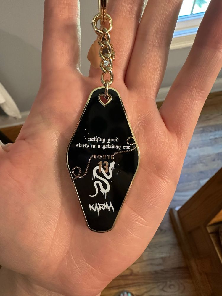 Getaway Car keychain from Grape Soda Club (back) - Route 13 with a snake & the word KARMA
