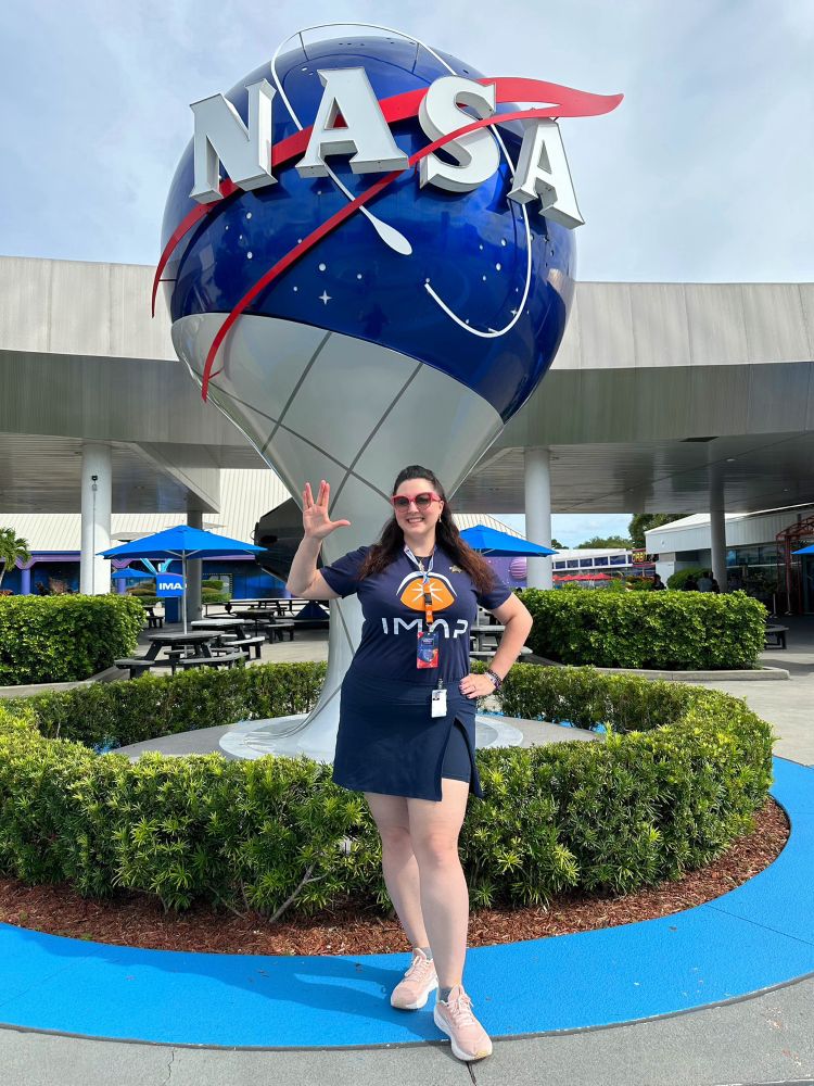 Amy standing in front of the NASA Globe at Kennedy Space Station wearing an IMAP mission logo shirt and throwing up the Vulcan salute 🖖🏻 For more mission info and super rad launch photos, follow @IMAPSpaceMission on Insta & FB 🚀