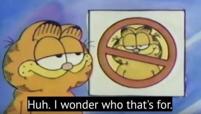 Garfield looking at a picture of himself with the general prohibition sign wondering who it is referring to.