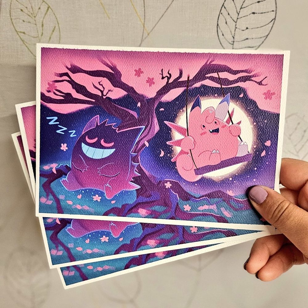 Image of me holding a few small prints of Gengar and Clefable.