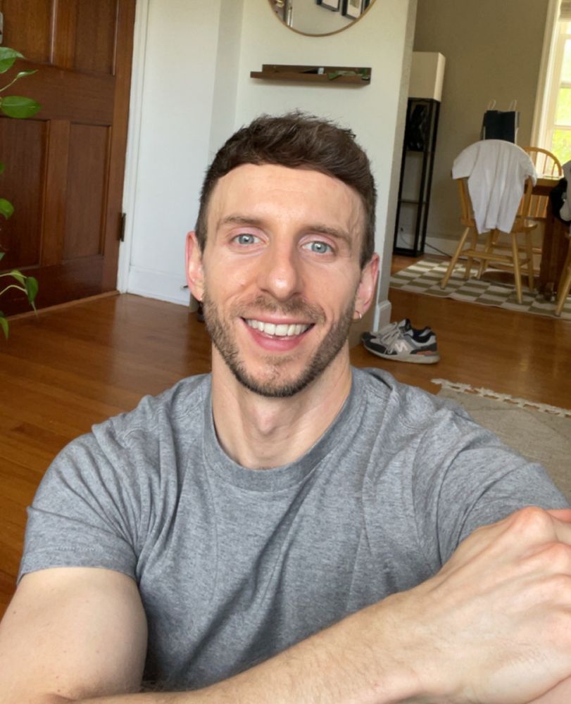 A selfie of a man in a shirt smiling 