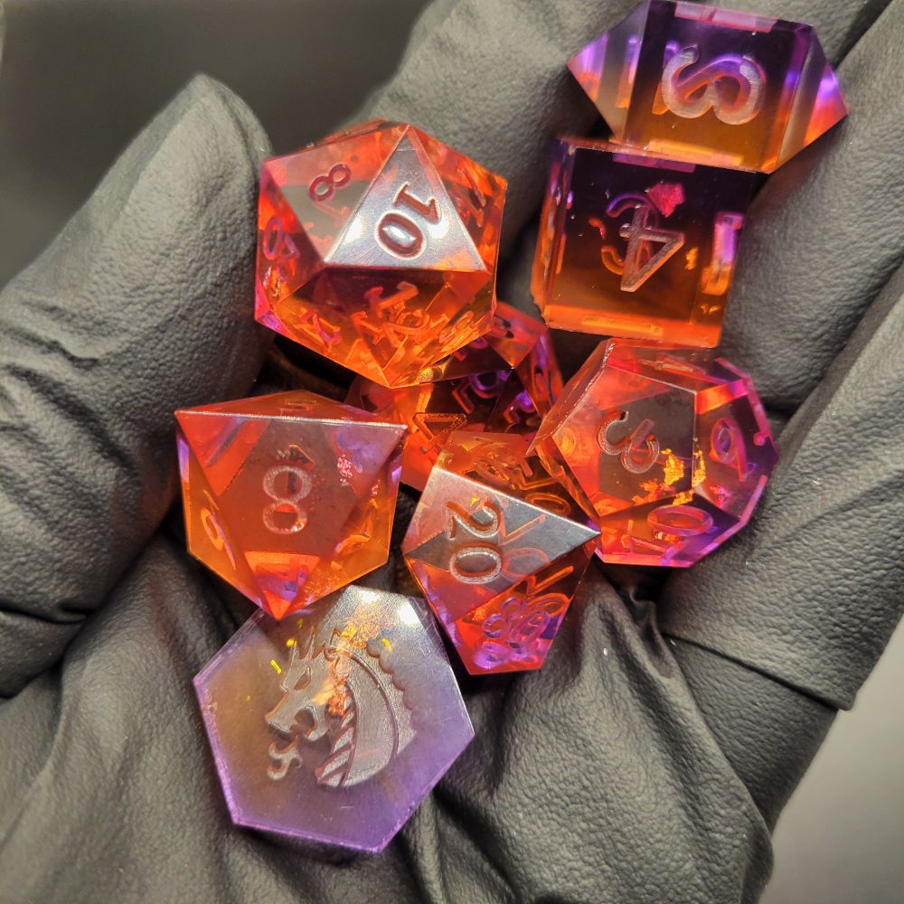 Orange and purple eight piece dice set for playing tabletop role playing games 