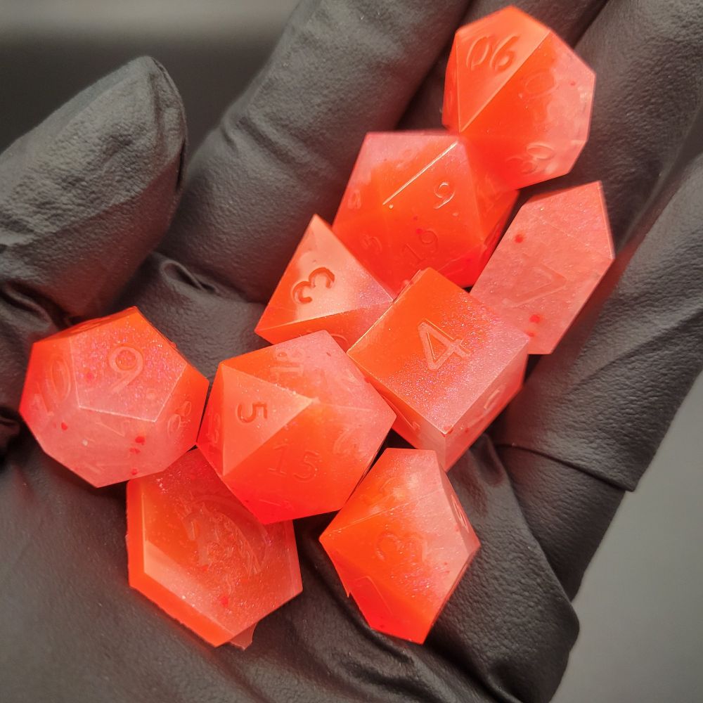 Hot orange neon nine piece dice set for playing tabletop role playing games 