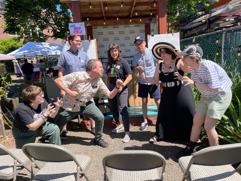 Cartoonists in fighting poses for Battle with Pictures