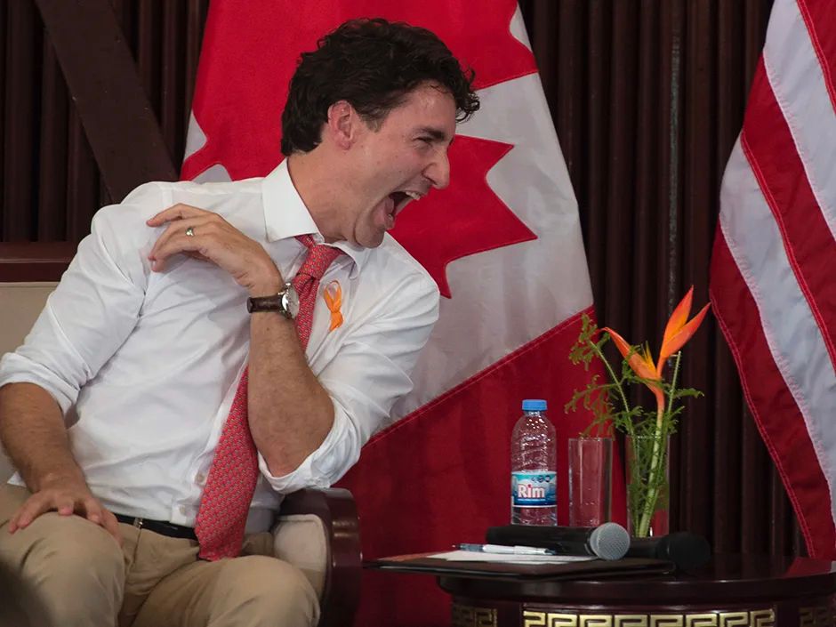 Former PM Justin Trudeau laughing with his mouth wide open 