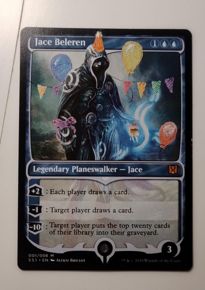  Jace Beleren {1}{U}{U}

Legendary Planeswalker — Jace

+2: Each player draws a card.

−1: Target player draws a card.

−10: Target player mills twenty cards.
Loyalty: 3

Illustrated by Aleksi Briclot 

The card is altered to have three balloons, a line with little flags, a party hat on Jace's head and a cupcake in Jace's hand, and a ribbon around his other hand. 