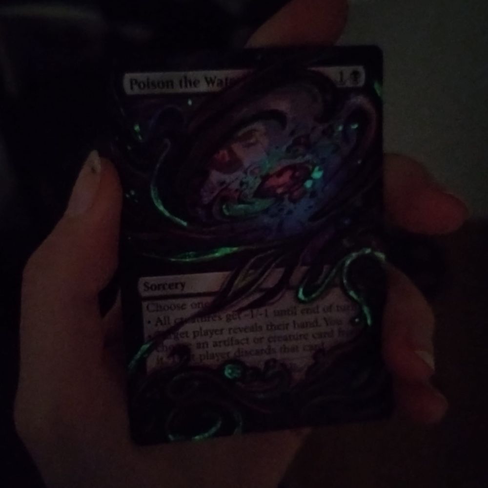 The same card, but photographed in the dark. The light green parts are faintly glowing.  